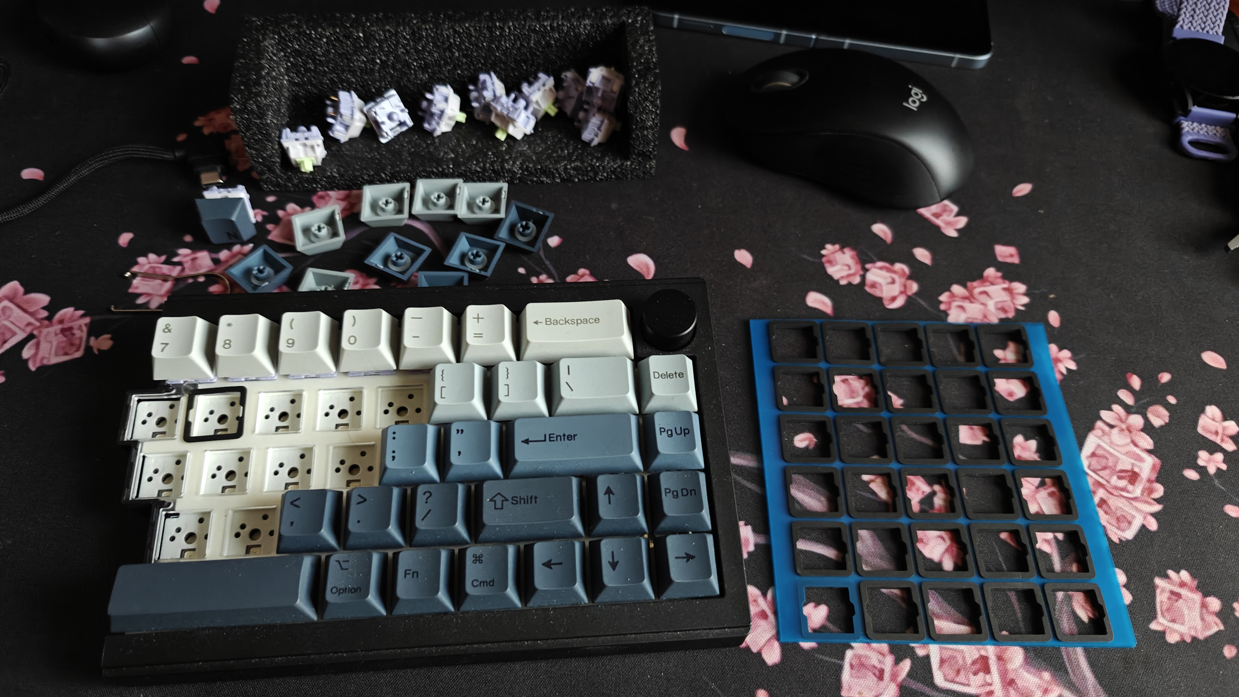 Mid-assembly showing switches being tested with blue organizer tray